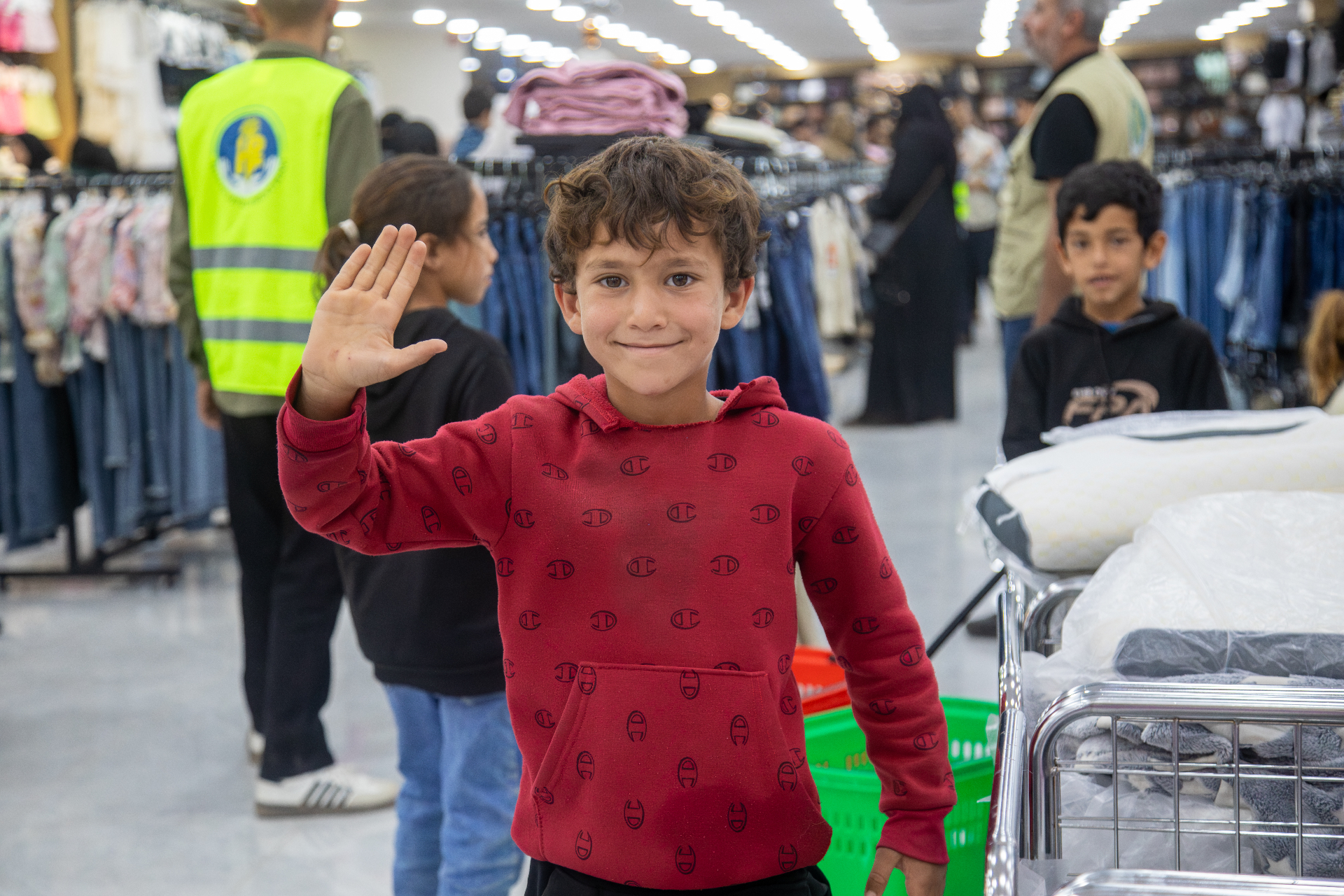 A child from an HDF beneficiary family in Al Marfaq, Jordan, waving while shopping for Eid.